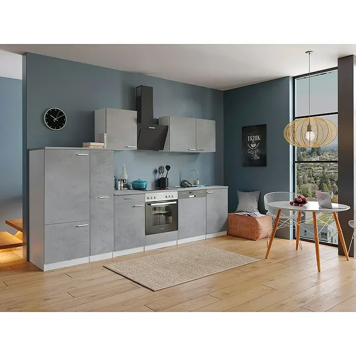 Respekta Küchenzeile Malia Typ 2 - Breite: 310 cm, Beton, Mit Elektrogeräten - Helle Küche mit grauen Schränken, Essecke mit rundem Tisch und Blick auf die Landschaft durch das große Fenster. Moderne Küchenausstattung.