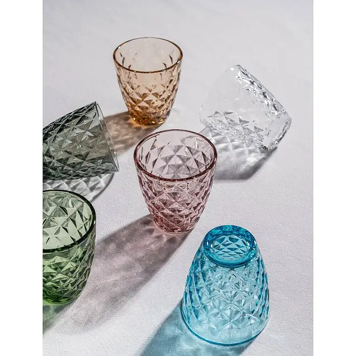 Trinkglas Prisma - 4 Stk., Fassungsvermögen: 0,22 l, Grau - Farbige Kristallgläser mit Rautenmuster auf weißem Stoff. Die Gläser in Gelb, Pink, Blau, Grün, Grau und Klar sind dekorativ.
