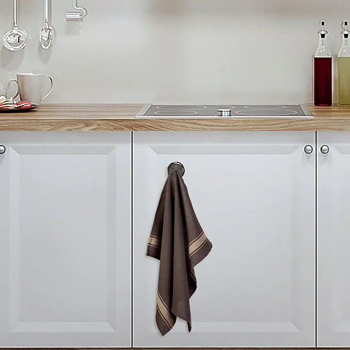 Colgador de trapos de cocina - Cromo - Paño de cocina colgando de un pomo en un armario blanco de cocina.