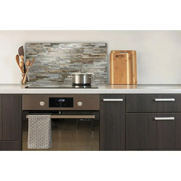 CUCINE Küchenrückwand - Rocky Wall, 80 x 40 cm, Stärke: 6 mm, Einscheibensicherheitsglas (ESG) - Küchenszene mit einem modernen Ofen, Kochfeld, Kochtopf, Schneidebrettern und Utensilien. Der Fokus liegt auf dem eleganten Design und der Funktionalität.