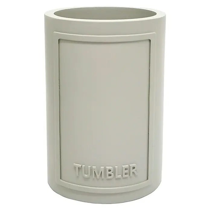 Bath Stage Portacepillos B-Aqua - Diámetro: 7 cm, Plástico - Primer plano de un vaso gris con la palabra "TUMBLER" escrita, sobre un fondo negro, perfecto para el uso diario.