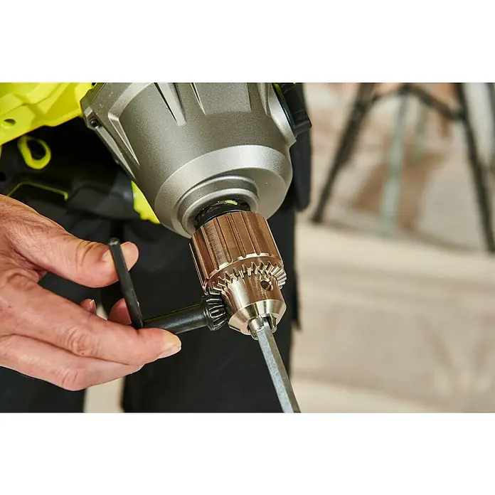 Ryobi ONE+HP Akku-Rührwerk RPM18X-0 - 18 V, Anzahl Akkus: Ohne Akku - Nahaufnahme einer Bohrmaschine, bei der ein Bohrer mit einem Bohrfutterschlüssel festgezogen wird. Ryobi Bohrmaschine mit Bohrer im Detail.