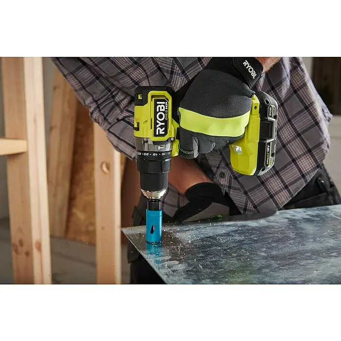 Ryobi ONE+ Akku-Schlagbohrschrauber RPD18C1-0 C - 18 V, Ohne Akku, 60 Nm - Der gelbe Ryobi ONE+ HP Akku-Bohrschrauber mit blauem Bohrkronenaufsatz bohrt ein Loch in eine metallische Oberfläche.