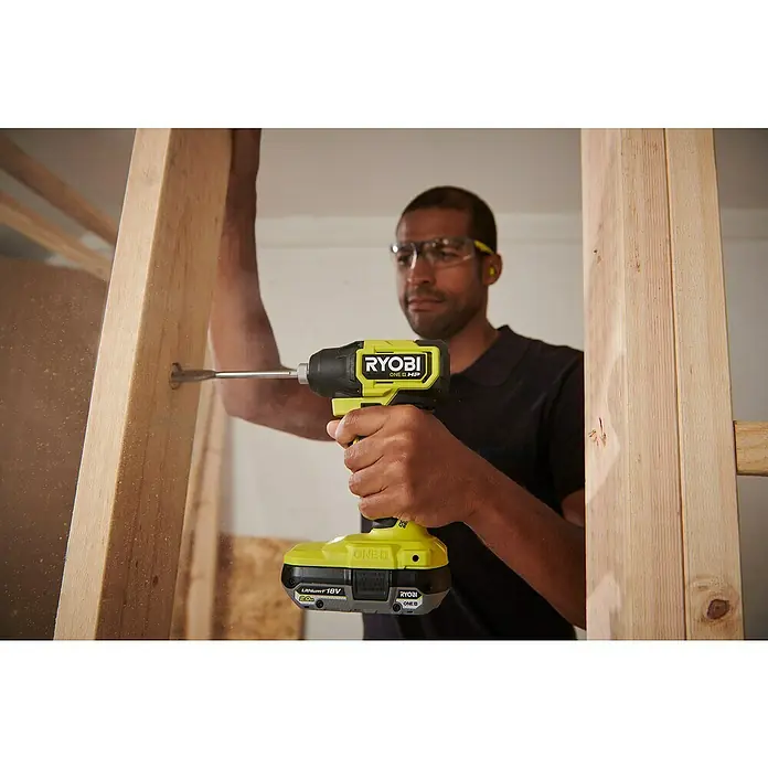 Ryobi ONE+HP Akku-Schlagschrauber RID18C1-0 - 18 V, Ohne Akku, 240 Nm - Mann benutzt einen gelben Ryobi ONE+ HP Akku-Schlagschrauber, um an einem Holzrahmen zu arbeiten.
