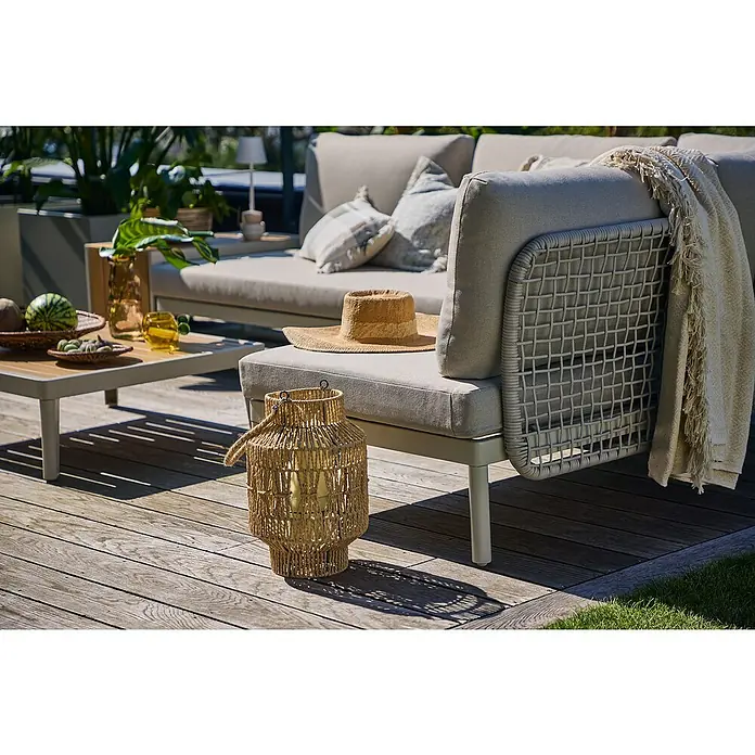Sunfun Solo Rope Módulo de conjunto de respaldo con cojín - Aluminio, Gris claro - Elegante escena de jardín con una linterna de ratán decorativa al lado de un moderno sofá lounge en una terraza de madera.