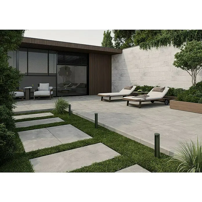 Queens Terrassenfliese - 59,3 x 119,3 x 2 cm, Grau, Matt - Bild eines eleganten Außenbereichs mit stilvollen Liegestühlen, modernem Gebäude und gepflegten Grünflächen.