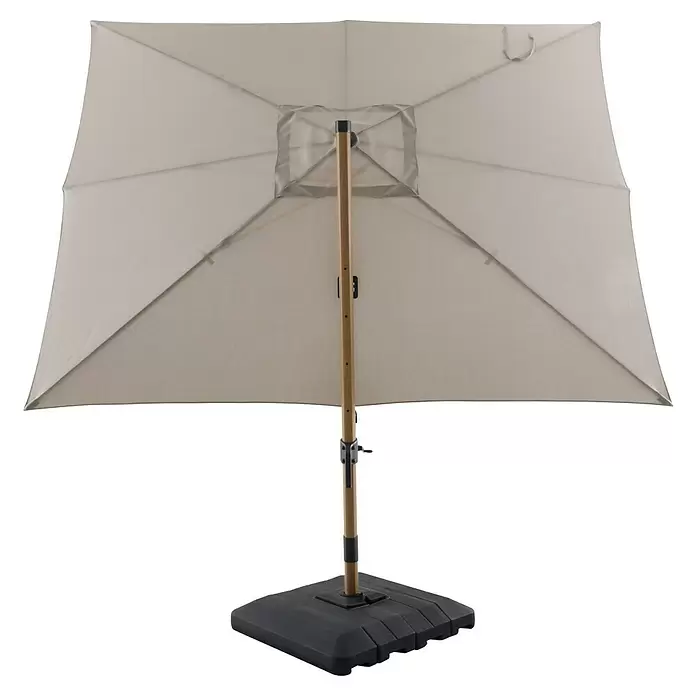 Sunfun Ampelschirm Capri - Beige, 300 x 350 cm, Aluminium - Rechteckiger beigefarbener Sonnenschirm mit braunem Mast und dunkelgrauem Fuß, von unten gesehen.