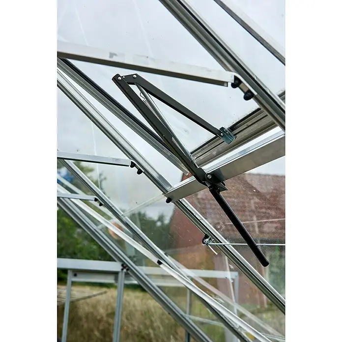 Halls Gewächshaus Magnum 128 - Außenmaß inkl. Dachüberstand (B x T): 257 x 384 cm, Material Seitenwand: Glas, 3 mm, Silbergrau, Sicherheitsglas - Nahaufnahme eines automatischen Fensteröffners in einem Gewächshaus, der für optimale Belüftung sorgt.