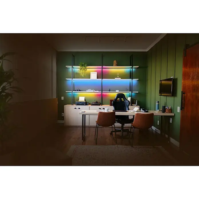 MegaLight LED-Stripes - Länge: 5 m, RGB, 250 lm - Ein gemütliches Arbeitszimmer mit Regalen, die mit farbigen Lichtern beleuchtet sind, einem Schreibtisch und bequemen Stühlen.