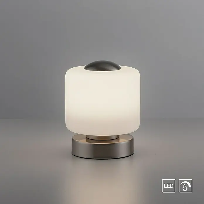Just Light Lámpara de sobremesa LED Bota - 5 W, L x An x Al: 12 x 12 x 15 cm, Blanco, Blanco cálido - Primer plano de una lámpara de mesa moderna y elegante con tecnología LED y función de atenuación táctil sobre fondo gris.