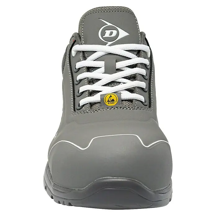 Dunlop Zapato bajo de seguridad Matt - 44, Clase de protección según EN ISO 20345: S3, Gris - Primer plano de un zapato de seguridad gris de Dunlop con cordones blancos y un símbolo ESD para la protección contra descargas electrostáticas.
