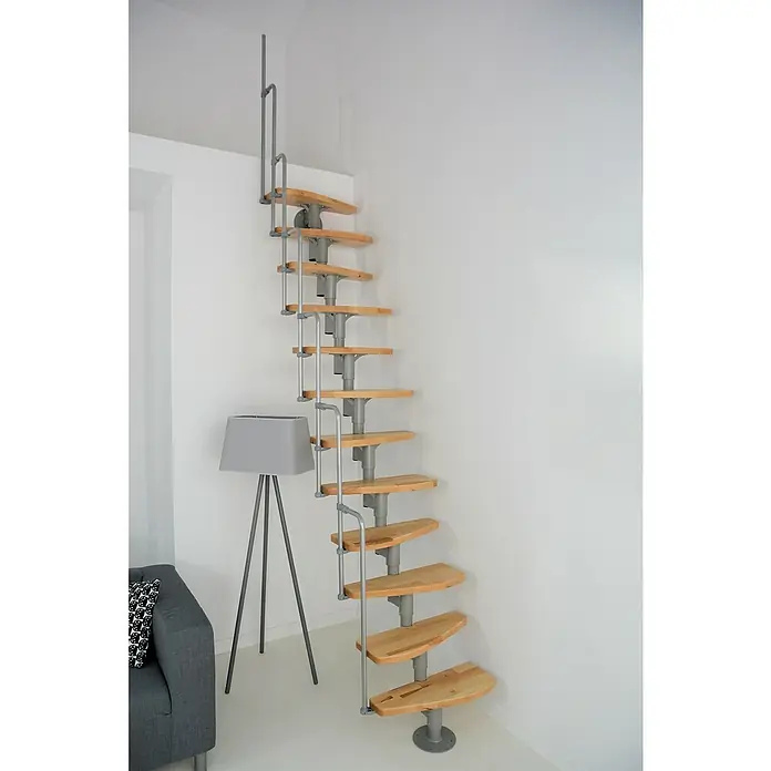 Minka Raumspartreppe Monaco - Breite: 60 cm, Grau, Farbe Stufen: Buche Natur, Geschosshöhe: 294 cm - Eine Wendeltreppe mit Holzstufen und einem grauen Metallgeländer ist in einer Ecke eines Raumes angebracht und bietet einen stilvollen Aufgang.