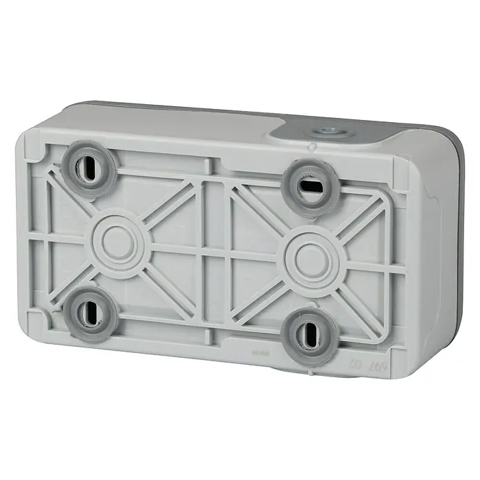 Legrand Plexo Enchufe para estancias con humedad doble - Gris, Alineación de los mecanismos: Vertical, Montaje en superficie, IP55 - La parte inferior de un producto rectangular gris-blanco con cuatro patas redondas de goma gris. Una estructura de rejilla refuerza la base.