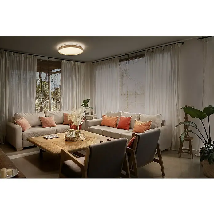 Ledvance Orbis LED-Deckenleuchte rund Alison - 16 W, Ø x H: 29,5 x 6 cm, Holzdekor, Warmweiß - Ein einladendes Wohnzimmer mit einer runden Deckenleuchte, die sanftes Licht spendet. Warme Farben und natürliche Materialien schaffen eine behagliche Atmosphäre.