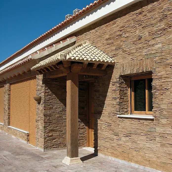 Revestimiento de piedra Petra Mineral - Cantidad total: 4 pzs., Mineral - Casa rústica con fachada de piedra natural, ventana con marco de madera y entrada cubierta con columna de madera.