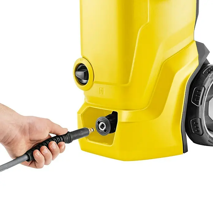 Kärcher Hochdruckreiniger K 7 WCM Pure Flex Home - 3.000 W, Max. Druck: 180 bar, Fördermenge: 600 l/h - Detailaufnahme eines gelben Kärcher Hochdruckreinigers mit einer Hand, die einen Schlauch anschließt.