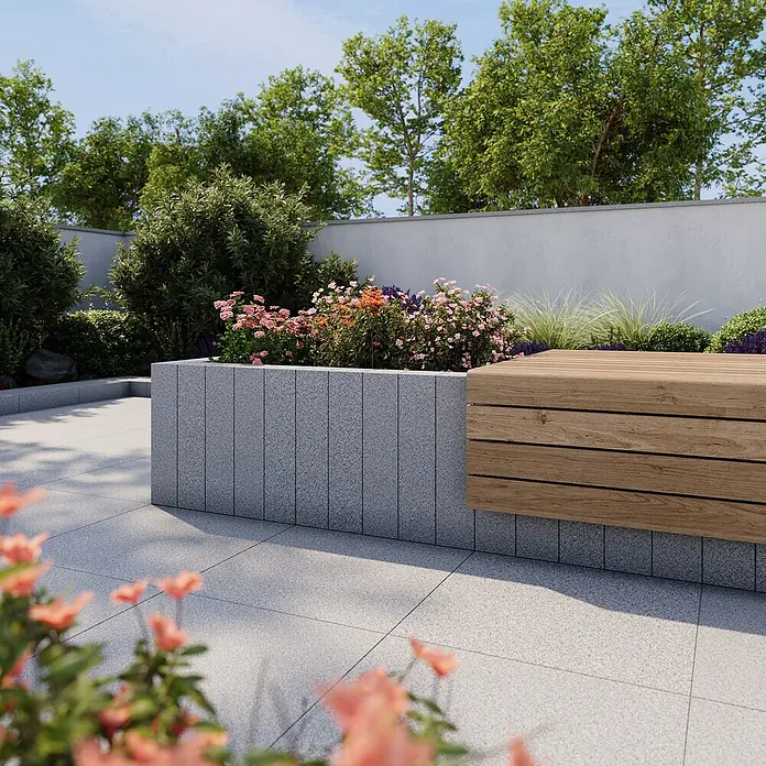 Palisade G 603 - 100 x 12 x 12 cm, Grau - Nahaufnahme einer stilvollen Gartenbank aus Holz und Stein, umgeben von üppiger Bepflanzung und Blumen. Die Bank bietet einen bequemen Platz zum Entspannen im Freien.