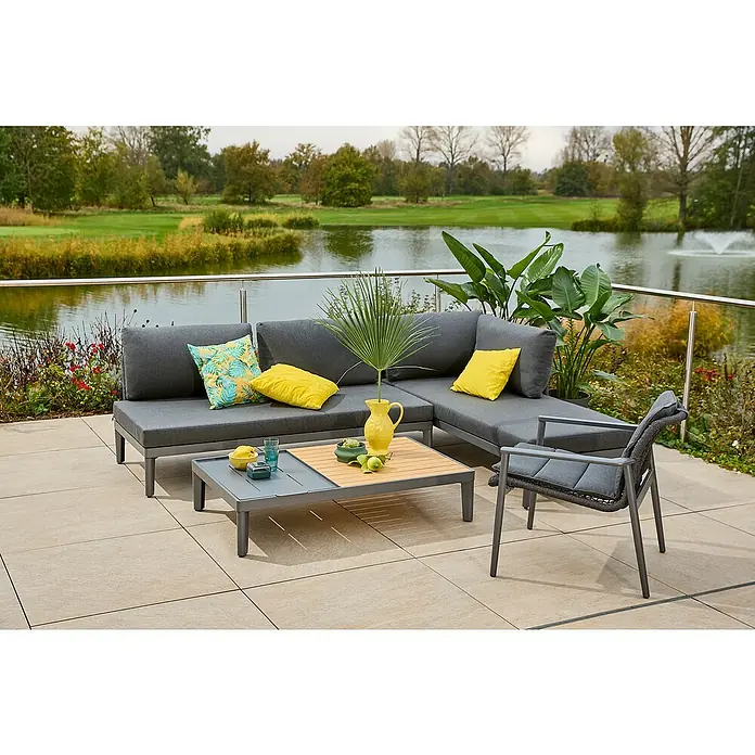 Sunfun Solo Rope Loungesessel - B x T x H: 69,5 x 74 x 72 cm, Aluminium, Kunststoff, Night-Grey - Eine stilvolle graue Lounge-Ecke mit Tisch und Stuhl vor einem malerischen See. Perfekt für entspannte Stunden im Freien.