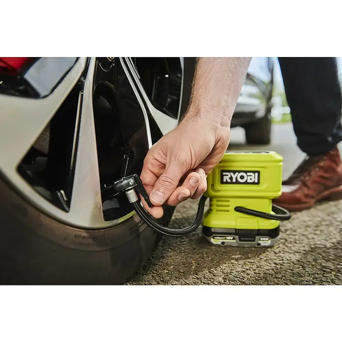 Ryobi ONE+ Akku-Kompressor RPI18-0 - 18 V, Ohne Akku, 10,3 bar - Ein Ryobi Luftkompressor wird verwendet, um einen Autoreifen aufzupumpen. Das kompakte Gerät ist ideal für unterwegs.