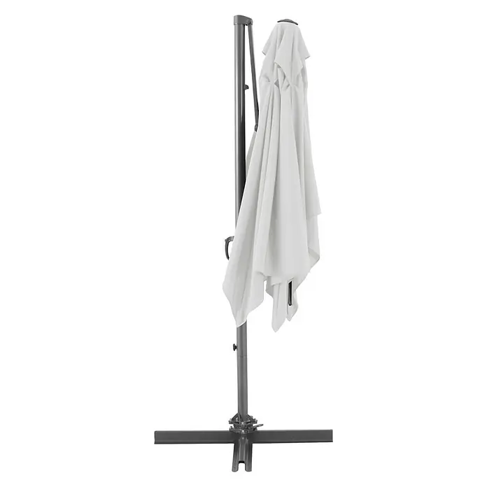 Sunfun Parasol de jardín Florenz - Crudo, 200 x 250 cm, Aluminio - Primer plano de una sombrilla voladiza blanca cerrada con pie en cruz y marco gris.