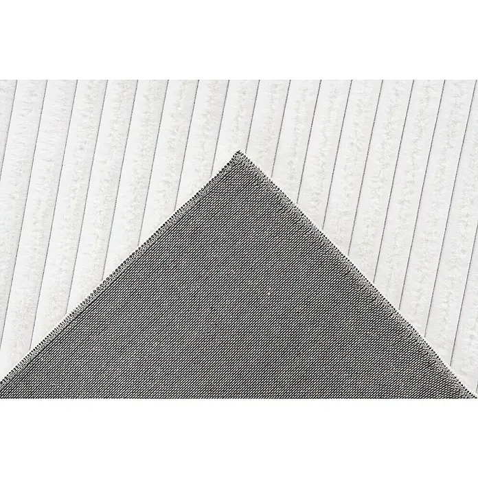 Hochflorteppich Plush - Ivory, 150 x 80 cm, 100 % Polyester - Nahaufnahme einer Wendematte mit weichen, weißen Streifen auf der einen und einem grauen Textilmuster auf der anderen Seite.