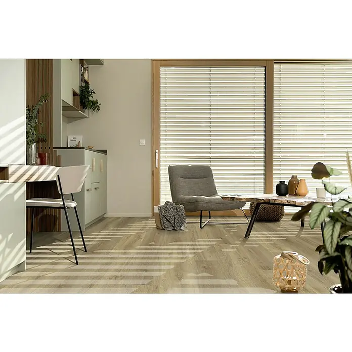 Gerflor Vinylbodenmuster Rigid Acoustic Alana Medium - 250 x 229 x 5,4 mm, Alana Medium - Einladender Wohnraum mit stilvollen Jalousien, einem bequemen Sessel und einem Holztisch, der eine harmonische Atmosphäre schafft.