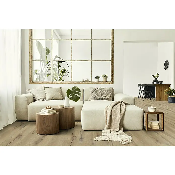 Gerflor Vinylbodenmuster Rigid Acoustic Paloma Brown - 250 x 229 x 5,4 mm, Paloma Brown - Helle Wohnzimmerausstattung mit beigem Sofa, Holzböden und rustikalem Fensterrahmen, die eine gemütliche Atmosphäre schaffen.