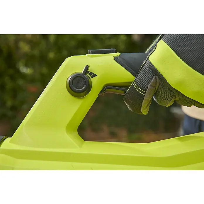 Ryobi ONE+HP Akku-Laubbläser RY18BLXD-0 Whisper - Ohne Akku, Blasgeschwindigkeit: 200 km/h, Blasleistung: 12,75 m³/min - Nahaufnahme einer gelben RYOBI Akku-Laubbläsers mit Geschwindigkeitsregler und einer Hand mit Schutzhandschuh, die den Auslöser betätigt.