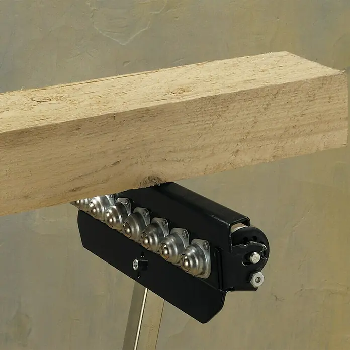Wolfcraft Caballete multifuncional - Ajuste de altura: 630 mm - 1.000 mm, Carga soportada: 50 kg - Primer plano de un caballete de rodillos que soporta una tabla de madera. Diseño robusto para proyectos de carpintería.