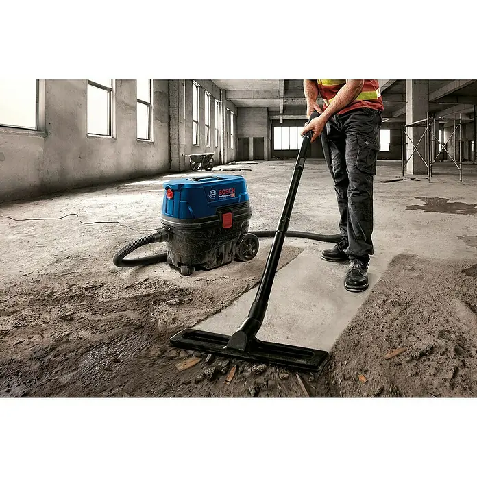 Bosch Professional Elektro-Nass- & Trockensauger GAS 12-25 PL - 1.250 W, Behältervolumen: 25 l, Mit Beutel - Bosch Professional Nass-Trockensauger im Einsatz auf einer Baustelle, der den Boden von Staub und Schmutz befreit.