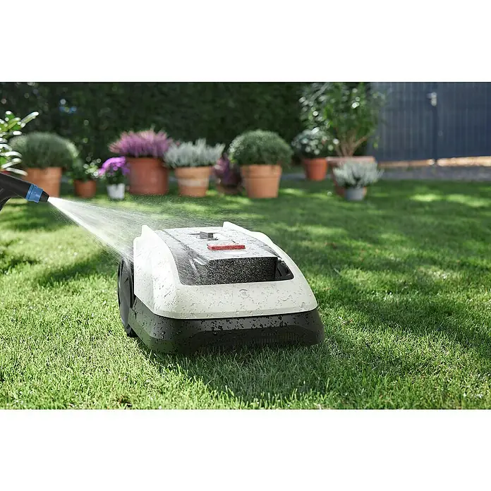 Ecovacs Goat Mähroboter O800 RTK - 800 m², Schnittbreite: 22 cm, Satellitengestützte Navigation, RTK - Ein Rasenmähroboter wird mit einem Wasserschlauch gereinigt, um ihn sauber zu halten. Perfekt für einen gepflegten Garten.