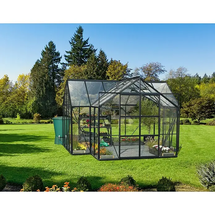 Vitavia Gewächshaus Sirona - Außenmaß inkl. Dachüberstand (B x T): 383 x 383 cm, 3 mm, Schwarz - Ein geräumiges Gewächshaus mit Pflanzen und Regentonnen in einem üppigen Garten, perfekt für Pflanzenliebhaber.