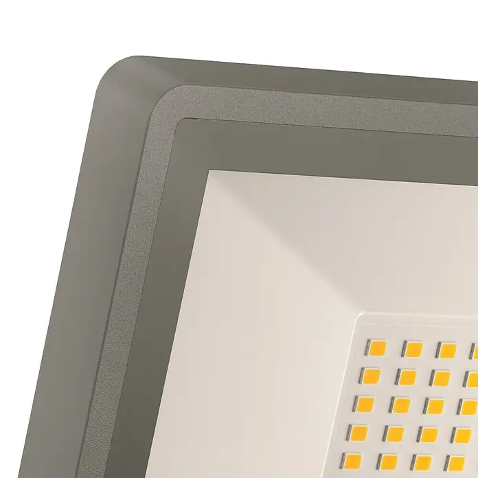 Steinel Proyector LED XLED ONE - 17,8 W, L x An x Al: 17,3 x 22,9 x 19,5 cm, Acero inoxidable, Blanco cálido - Primer plano de un foco LED gris con puntos de luz rectangulares.