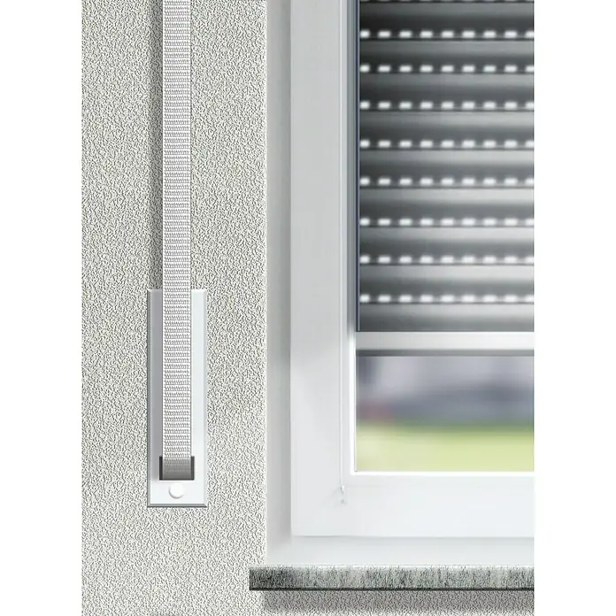 Schellenberg Rollladengurt MiniBeige, Länge: 6 m, Gurtbreite: 14 mm - Nahaufnahme eines Rollladengurts mit Gurtwickler an einer Wand neben einem Fenster mit Rollladen.