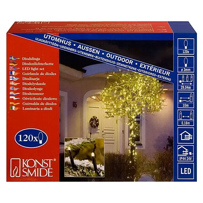 Konstsmide LED-Lichterkette Micro LED - Außen, Lichtfarbe: Warmweiß, Anzahl Leuchtmittel: 120 Stk., Netzbetrieben - Konst Smide Outdoor-LED-Lichterkette mit 120 warmweißen LEDs, auf der Verpackung abgebildet, wie sie einen Baum beleuchtet.