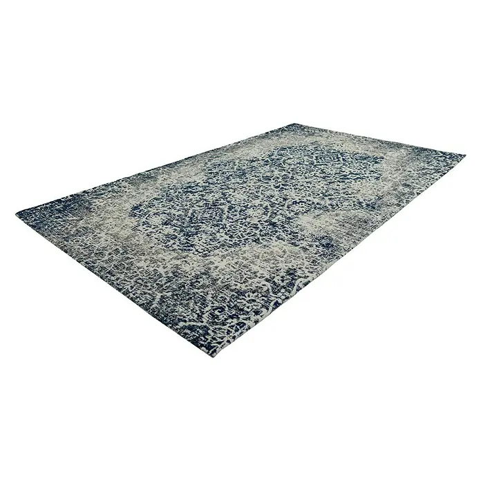 Kayoom Flachgewebeteppich River 140 - Multi, 150 x 80 cm, 70 % Baumwolle, 30 % Polyester - Ein rechteckiger Teppich mit blau-grauem Muster liegt auf dem Boden und verleiht jedem Raum einen stilvollen Akzent.
