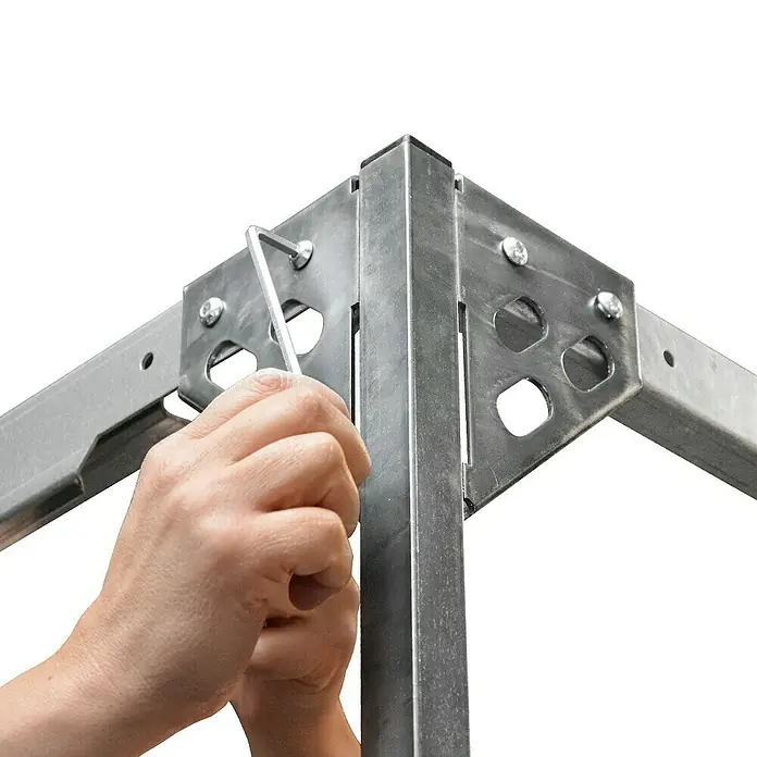 Stema Hochplanen-Set 25-13 - Passend für: Stema Anhänger Basic -25-13er-Serie, Höhe: 100 cm - Nahaufnahme einer Person, die mit einem Inbusschlüssel ein Metallrahmenelement befestigt und die Stabilität und Konstruktion hervorhebt.