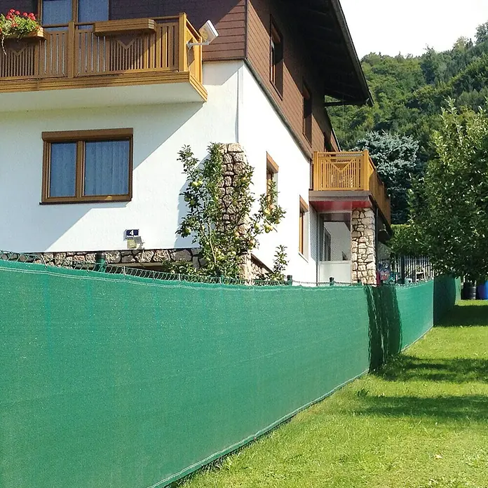 Zaunblende Meterware - Höhe: 0,8 m, HDPE Gewebe, Grün - Sichtschutznetz vor einem Haus, das Privatsphäre bietet und gleichzeitig die Ästhetik des Gartens bewahrt.