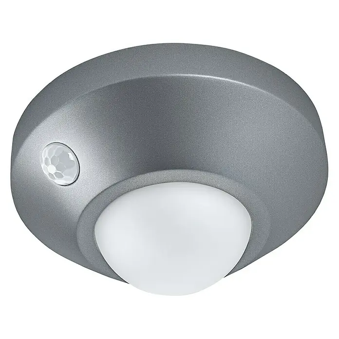 Osram LED-Nachtlicht Ceiling - Schwarz, Ø x H: 86 x 47 mm - Nahaufnahme einer silbernen Deckenleuchte mit Bewegungsmelder und abgerundetem Lampenschirm vor schwarzem Hintergrund.