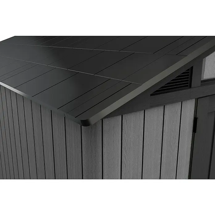 Keter Gerätehaus Stronghold 10x8 - Außenmaß inkl. Dachüberstand (B x T): 304 x 243 cm, Kunststoff, Grau - Detailansicht eines modernen Gartenhauses mit geradlinigem Design und dunkler Holzverkleidung. Das Dach ist flach und in dunklem Farbton gehalten.