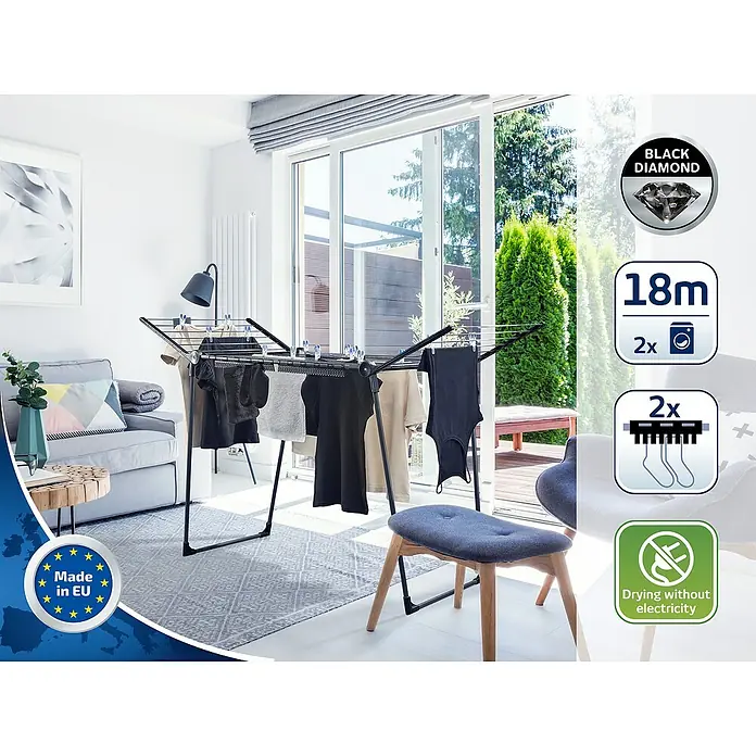 Leifheit Flügel-Wäscheständer Pegasus 180 Solid Black - Länge Wäscheleine: 18 m, Schwarz, B x T x H: 157 x 66 x 87 cm - Bild eines Black Diamond Wäscheständers mit aufgehängter Wäsche in einem hellen Wohnraum.
