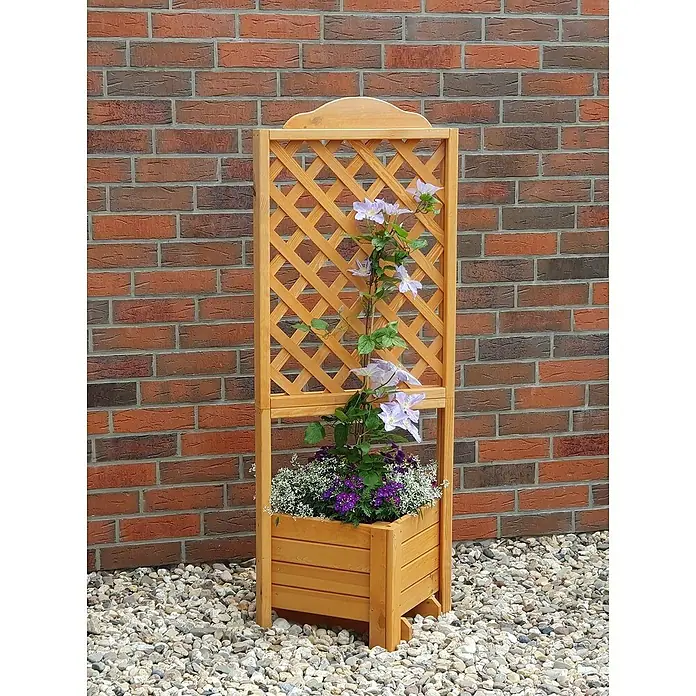 Promadino Pflanzkasten Romantica - Außenmaß (L x B x H): 140 x 38 x 38 cm, Holz, Honigbraun - Ein hölzernes Pflanzgefäß mit Rankgitter, bepflanzt mit bunten Blumen, vor einer Backsteinmauer, ideal für Garten und Terrasse.