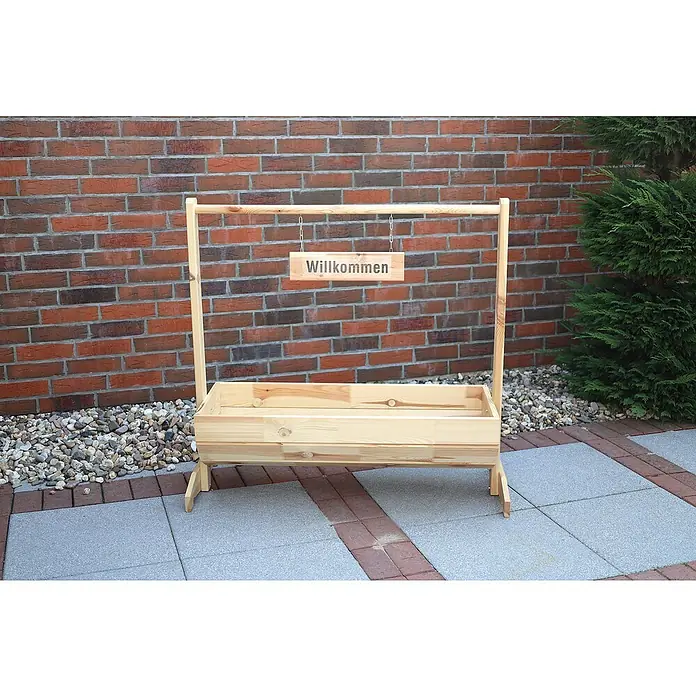 Promadino Pflanzkasten Willkommen - Außenmaß (L x B x H): 103 x 40 x 110 cm, Holz, Braun - Eine hölzerne Pflanzkasten-Struktur mit einem "Willkommen"-Schild vor einer Backsteinmauer und Steinen.