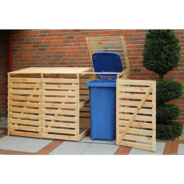 Promadino Mülltonnenbox Variov -  - Holzverkleidung für Mülltonnen im Garten. Die Mülltonne ist blau und der Deckel ist geöffnet. Im Hintergrund befindet sich eine Ziegelwand.