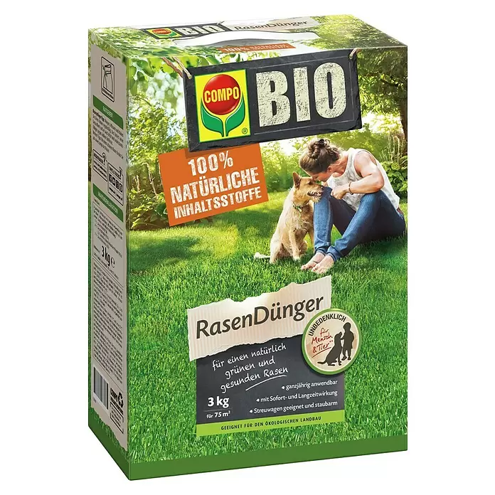 Compo Rasendünger - 3 kg, Max. Anwendungsfläche: 75 m² - Schachtel mit COMPO BIO Bio-Rasendünger, 3 kg, zeigt Frau und Hund auf grünem Rasen, hebt natürliche Inhaltsstoffe und Sicherheit hervor.