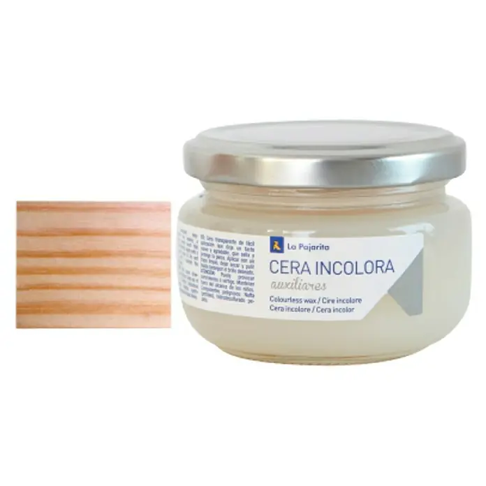 La Pajarita Cera - Incoloro, 100 ml - Imagen de una lata de cera incolora de La Pajarita, ideal para proteger y mantener superficies de madera, junto con un trozo de madera.