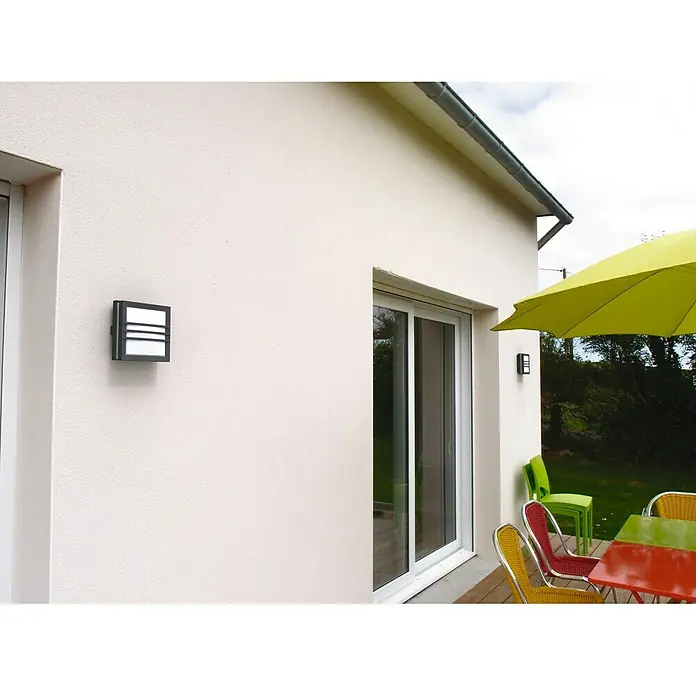 Lutec Aplique exterior LED Seine - 4 W, 5,4 x 14 x 14 cm, Antracita, IP54 - Primer plano de una moderna lámpara de exterior montada en una pared exterior blanca, que muestra un diseño elegante y minimalista.