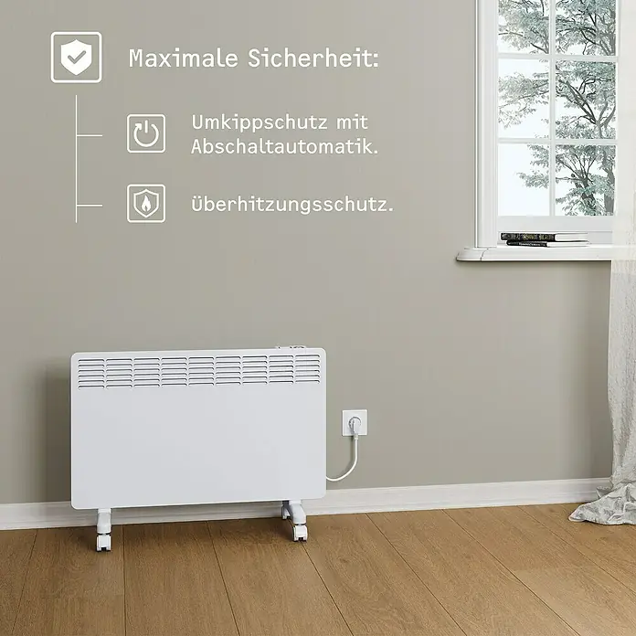 Stiebel Eltron Konvektorheizung EG-50-PL2-PE - 2.000 W, Raumheizvermögen: 25 m², Weiß - Das Bild zeigt einen weißen, elektrischen Heizkörper mit Rädern und Sicherheitsmerkmalen vor einer grauen Wand.