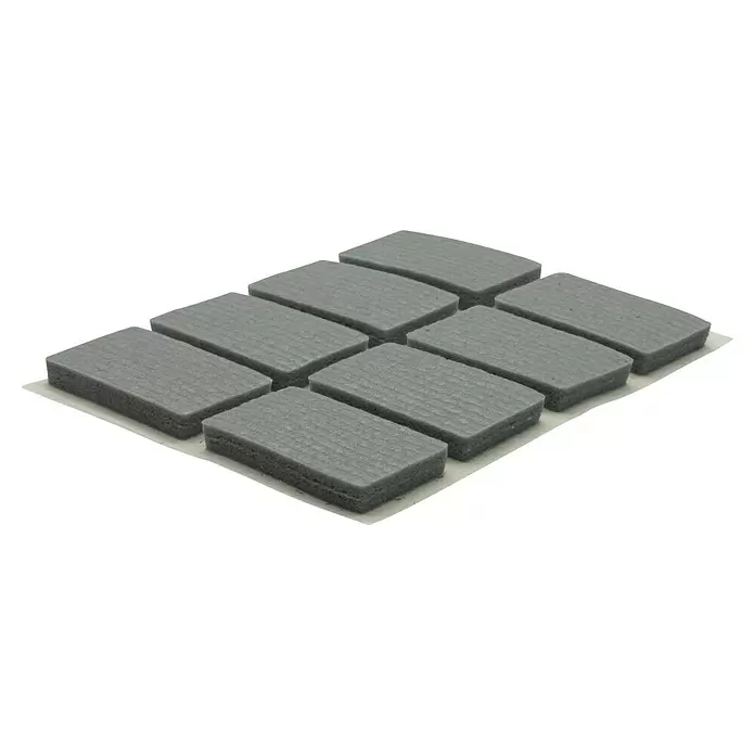 Wagner System Softpads - L x B x H: 26 x 16 x 4 mm, 16 Stk., Grau, Kleben - Neun graue rechteckige Filzgleiter auf einer Folie, gitterförmig angeordnet.