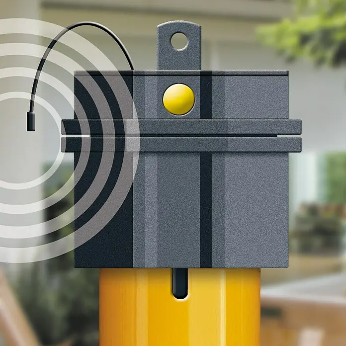 Schellenberg Motor tubular Maxi Premium - Fuerza de tracción: 10 kg - Primer plano de un dispositivo electrónico gris con un botón amarillo y un cilindro amarillo en la parte inferior, que emite ondas sonoras.